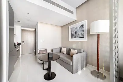 a living room with a couch and a table at ALiving Deluxe Studio I DAMAC Maison Prive, Business Bay -1204 in Dubai