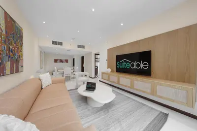 a living room with a couch and a tv at Discover unmatched Comfort in Downtown Dubai in Dubai