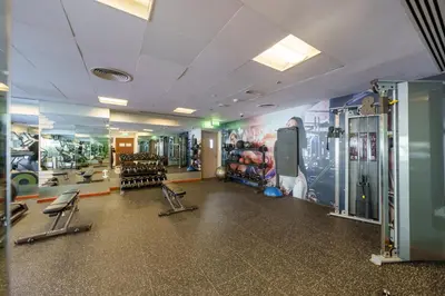 a gym with several treadmills and equipment in a room at Discover unmatched Comfort in Downtown Dubai in Dubai