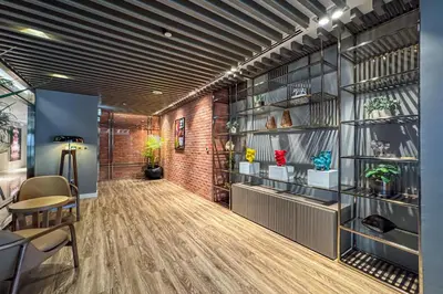 an office with a brick wall and a hallway at Stylish 2BR Retreat Wi-Fi & Pool Access in Dubai