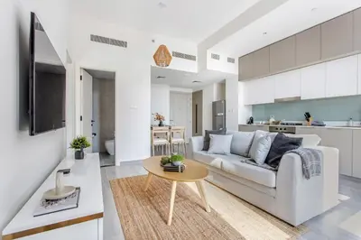 a living room with a couch and a table at Frank Porter - Noor 3 Midtown in Dubai