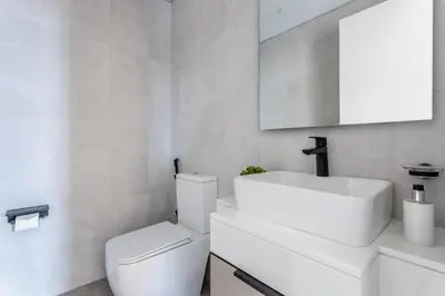 a bathroom with a white toilet and a sink at Frank Porter - Noor 3 Midtown in Dubai
