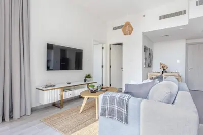a living room with a couch and a table at Frank Porter - Noor 3 Midtown in Dubai