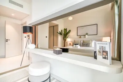 a living room with a large mirror on the wall at Seaside Splendor: Luxe Retreat at Emaar Beachfront in Dubai