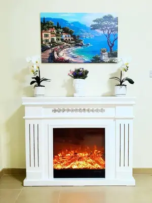 a white fireplace with a fire in it at JBR Retreat: Stylish Views in Dubai