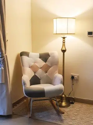 a living room with a chair and a lamp at JBR Retreat: Stylish Views in Dubai