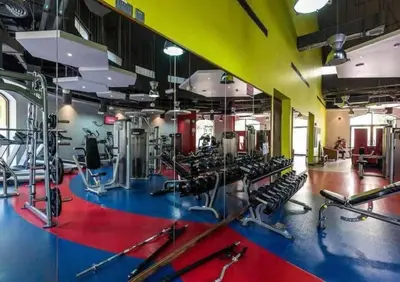 a gym with lots of treadmills and machines at JBR Retreat: Stylish Views in Dubai