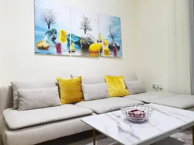 a living room with a couch and a table at JBR Retreat: Stylish Views in Dubai