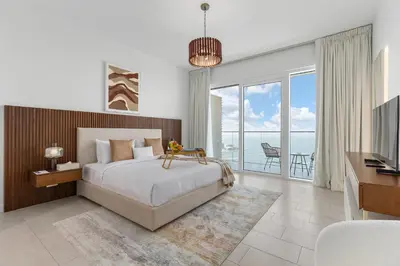 a bedroom with a bed and a view of the ocean at Maison Privee - Upscale Apt w/ Open Sea and Bluewaters Vws in JBR in Dubai