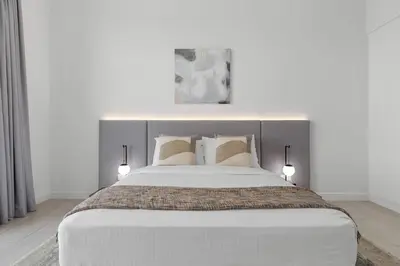 a bedroom with a large bed with two pillows at Maison Privee - Upscale Apt w/ Open Sea and Bluewaters Vws in JBR in Dubai