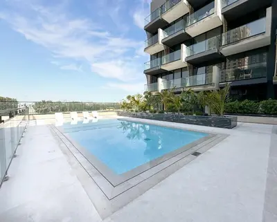 a swimming pool on the side of a building at Trophy - Stardust Sanctum Suites w Pool view in Heart of JVC in Dubai