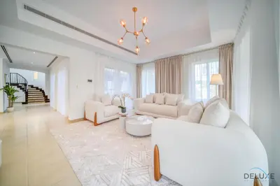 a living room with white furniture and a chandelier at Luxury 3BR Villa with Assistant Room at Alvorada 4 Arabian Ranches by Deluxe Holiday Homes in Dubai
