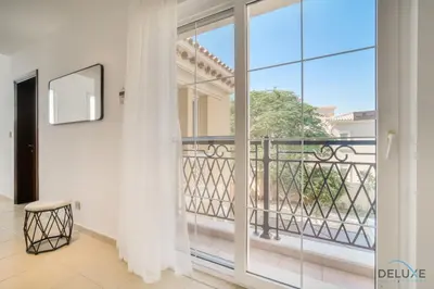 a room with a balcony with sliding glass doors at Luxury 3BR Villa with Assistant Room at Alvorada 4 Arabian Ranches by Deluxe Holiday Homes in Dubai