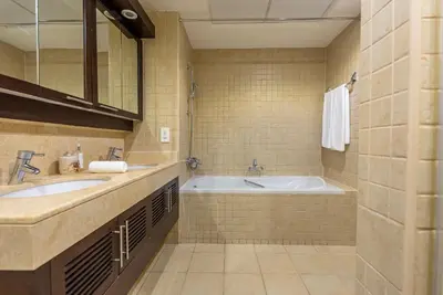 a bathroom with two sinks and a bath tub at Luxury 2BR Superior Apartment with Full Burj Khalifa and Dubai Mall Dancing Fountain View, Royal Tiffany in Dubai