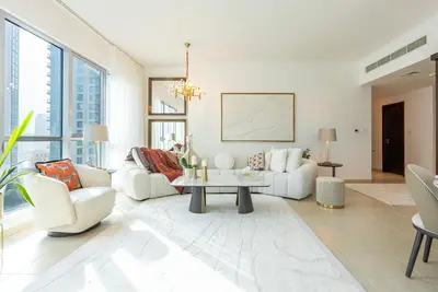 a living room with white furniture and large windows at Luxury 2BR Superior Apartment with Full Burj Khalifa and Dubai Mall Dancing Fountain View, Royal Tiffany in Dubai