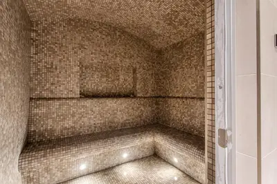 a bathroom with a shower with a tiled wall at STAY BY LATINEM Luxury 2BR Holiday Home W1813 near Burj Khalifa in Dubai