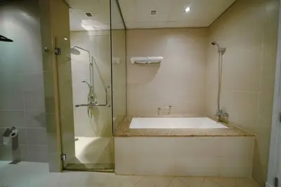 a bathroom with a tub and a glass shower at Palm Apt. with Burj al arab view in Dubai