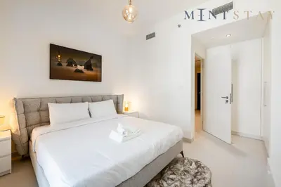 a bedroom with a large white bed in a room at Burj Crown , Downtown Dubai - Mint Stay in Dubai