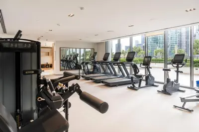 a gym with treadmills and elliptical machines at Burj Crown , Downtown Dubai - Mint Stay in Dubai