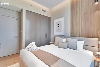 a bedroom with a large white bed in a room at bnbmehomes - Forte in Dubai