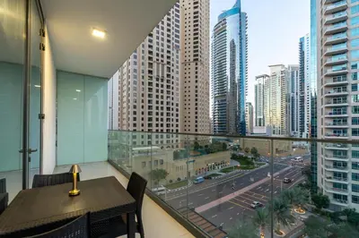 a balcony with a table and a view of a city at LIV Residence - Luxurious 2BR - Dubai Marina View - Marina Walk in Dubai