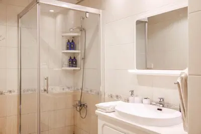 a bathroom with a shower and a sink and a mirror at Trophy - Marina Urban Serenity Suite in Dubai
