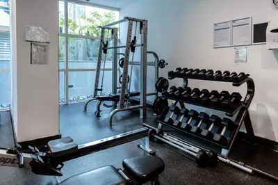 a room with a gym with a rack of weights at Trophy - Marina Urban Serenity Suite in Dubai