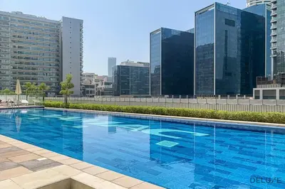 a large blue swimming pool on top of a building at Exclusive Deal, Chic 1BR at a Special Price by Deluxe Holiday Homes in Dubai