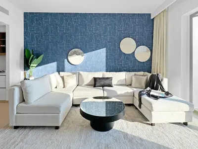 a living room with a couch and a table and mirrors at Amazing Burj Khalifa Views with Direct Dubai Mall Access, 2BR Apartment in Downtown Dubai in Dubai