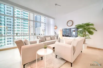 a living room with a couch and a table at Colossal 2BR at MAG 218 Dubai Marina by Deluxe Holiday Homes in Dubai