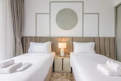 two beds sitting next to each other in a room at Marvelous Apartment in Beachfront Private Beach in Dubai