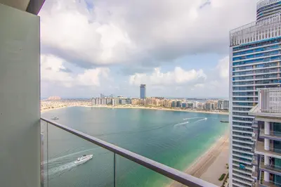 a view of the ocean from a balcony of a building at Marvelous Apartment in Beachfront Private Beach in Dubai