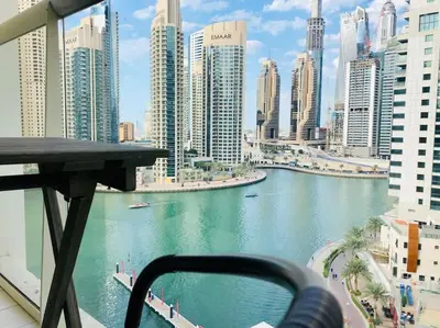 a view of a river in a city with tall buildings at Full sea view with balcony - Studio Apartment - 10 min to JBR - in Dubai