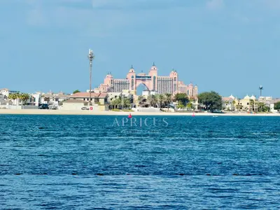 a large body of water with a resort in the background at Pleasant 1BD apartment with the beach access in Dubai