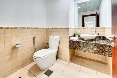 a bathroom with a toilet and a sink at Delightful 2BD apartment near the JBR in Dubai