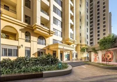 a large apartment building with a courtyard in front of it at Delightful 2BD apartment near the JBR in Dubai