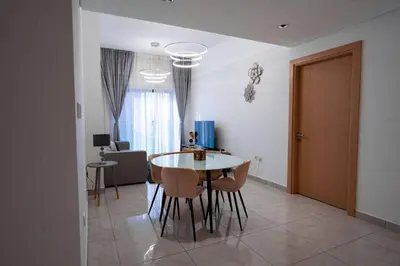 a dining room with a table and chairs in a room at Stylish 1 Bedroom With Amazing View in Dubai