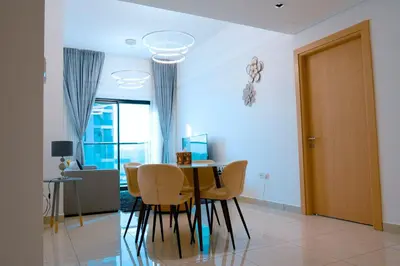 a dining room with a table and chairs at Stylish 1 Bedroom With Amazing View in Dubai