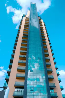 a tall building with a blue sky in the background at Stylish 1 Bedroom With Amazing View in Dubai