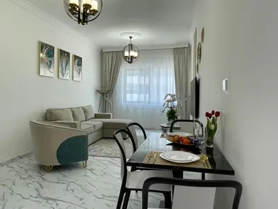 a living room with a table and a couch at Stay in heart of Dubai Marina walk to JBR beach 8 in Dubai