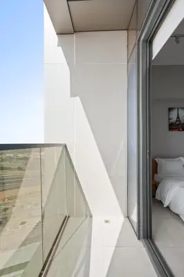 a glass staircase leading to a bedroom in a house at Studion In Dubailand - Close Kitchen in Dubai