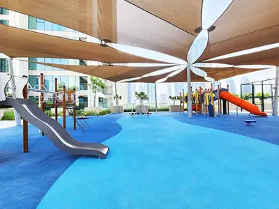 a playground with a slide and slides on a blue carpet at RH -Skyline Serenity, High-Floor Oasis in Downtown, walk to Burj Khalifa in Dubai