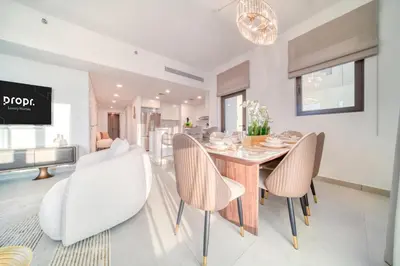a dining room with a table and chairs at Luxury Madinat Living 2BR with Sea Views in Dubai