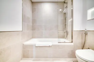 a bathroom with a bath tub and a toilet at Luxury Madinat Living 2BR with Sea Views in Dubai