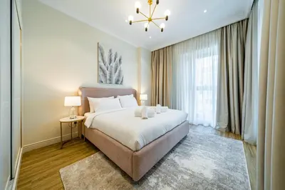 a bedroom with a bed and a large window at SettlerHomes - Sparkle Tower 2 with Stunning Views in Dubai