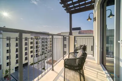 a balcony with two chairs on a building at Magnificent 2BR at La Voile Jumeirah by Deluxe Holiday Homes in Dubai