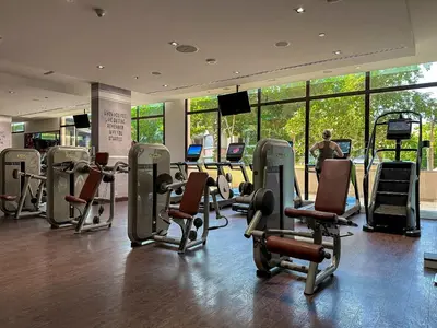 a gym with treadmills and chairs in a building at Elegant 1BR Full Palm View Apartment at 5 Star Resort in Dubai