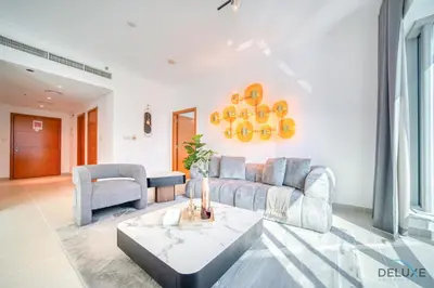 a living room with a couch and a table at Elegant 2BR at Beauport XI Dubai Marina by Deluxe Holiday Homes in Dubai