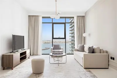 a living room with a couch and a tv at Silkhaus Ultra Luxury 1BDR with Sea View in Dubai