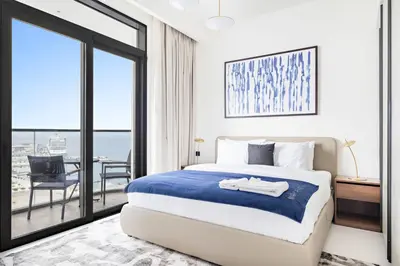 a bedroom with a bed and a large window at Silkhaus Ultra Luxury 1BDR with Sea View in Dubai